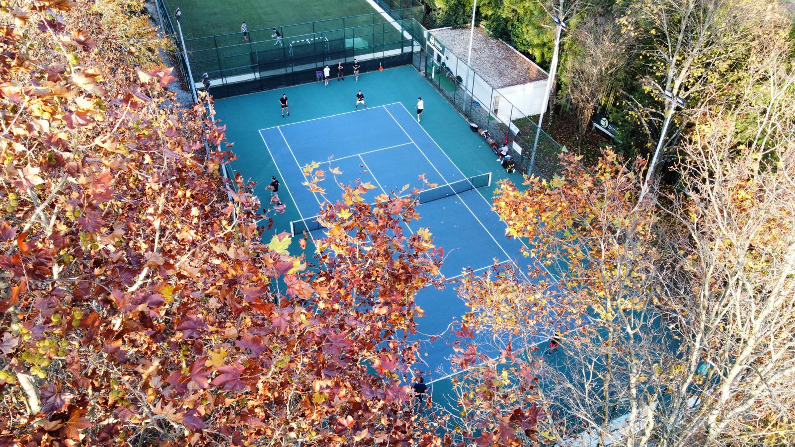 Vista aérea dos courts entre as árvores